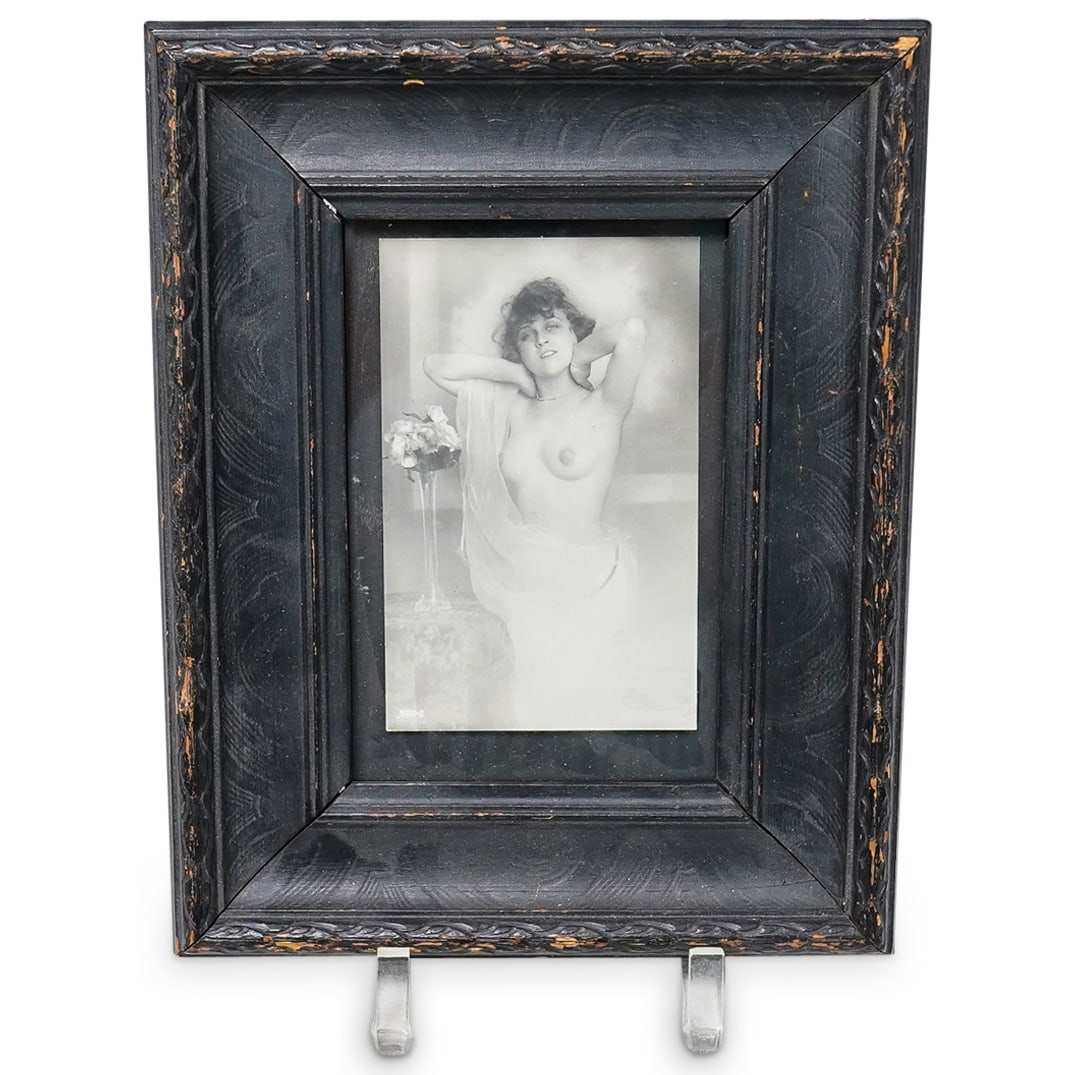 Antique French Erotic Nude Photograph: DESCRIPTION: Antique French erotic nude photograph, featuring a dark haired woman with her arms raised up to her head. Wearing a sheer robe that is draped over one arm. Framed in a black wooden frame.