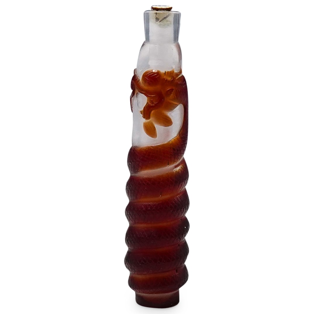 Chinese Dragon Peking Glass Snuff Bottle: DESCRIPTION: Antique peking glass snuff bottle, featuring an amber toned dragon wrapped around from the base to the top. CIRCA: 19th Century ORIGIN: China DIMENSIONS: H: 4.5" W: 1" CONDITION: Good con