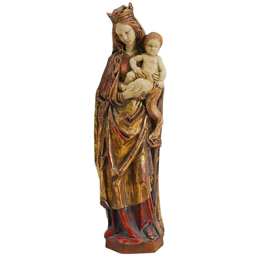 Antique Italian Carved Wood Madonna And Child: DESCRIPTION: Antique polychrome carved wood Madonna and Child sculpture depicting a crowned Mary carrying an infant Christ. CIRCA: 19th to early 20th Century ORIGIN: Italy DIMENSIONS: H: 10" W: 2.5" L