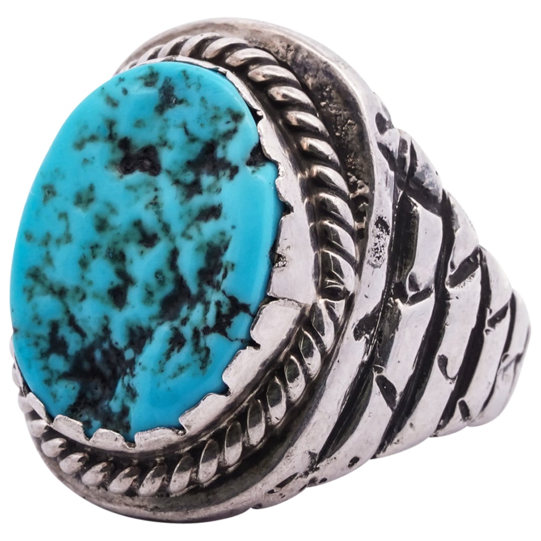 Native American Navajo Turquoise Ring: DESCRIPTION: Native American Navajo Turquoise Ring. In sterling silver with inlaid turquoise oval stone. Marked with' lighting bolt' hallmark, and 'Sterling' hallmarks. Total weight: grams. CIRCA: 20t