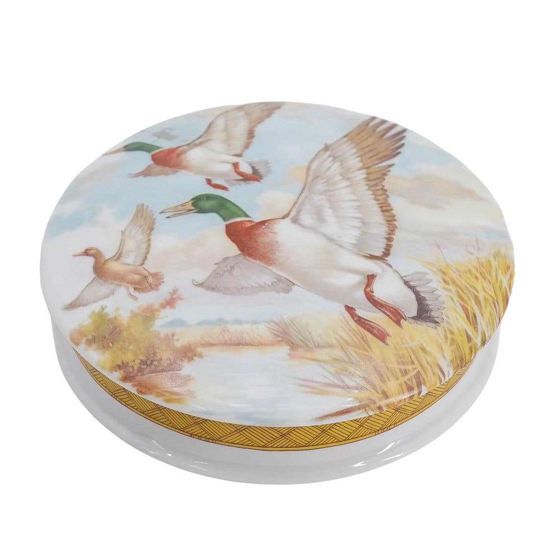 Limoges Porcelain Mallard Duck Trinket Box: DESCRIPTION: Limoges porcelain rounded lidded trinket box, featuring mallard ducks in flight on the lid. Stamped underside "Limoges France" CIRCA: 20th Century ORIGIN: France DIMENSIONS: H: 1" D: 5" C