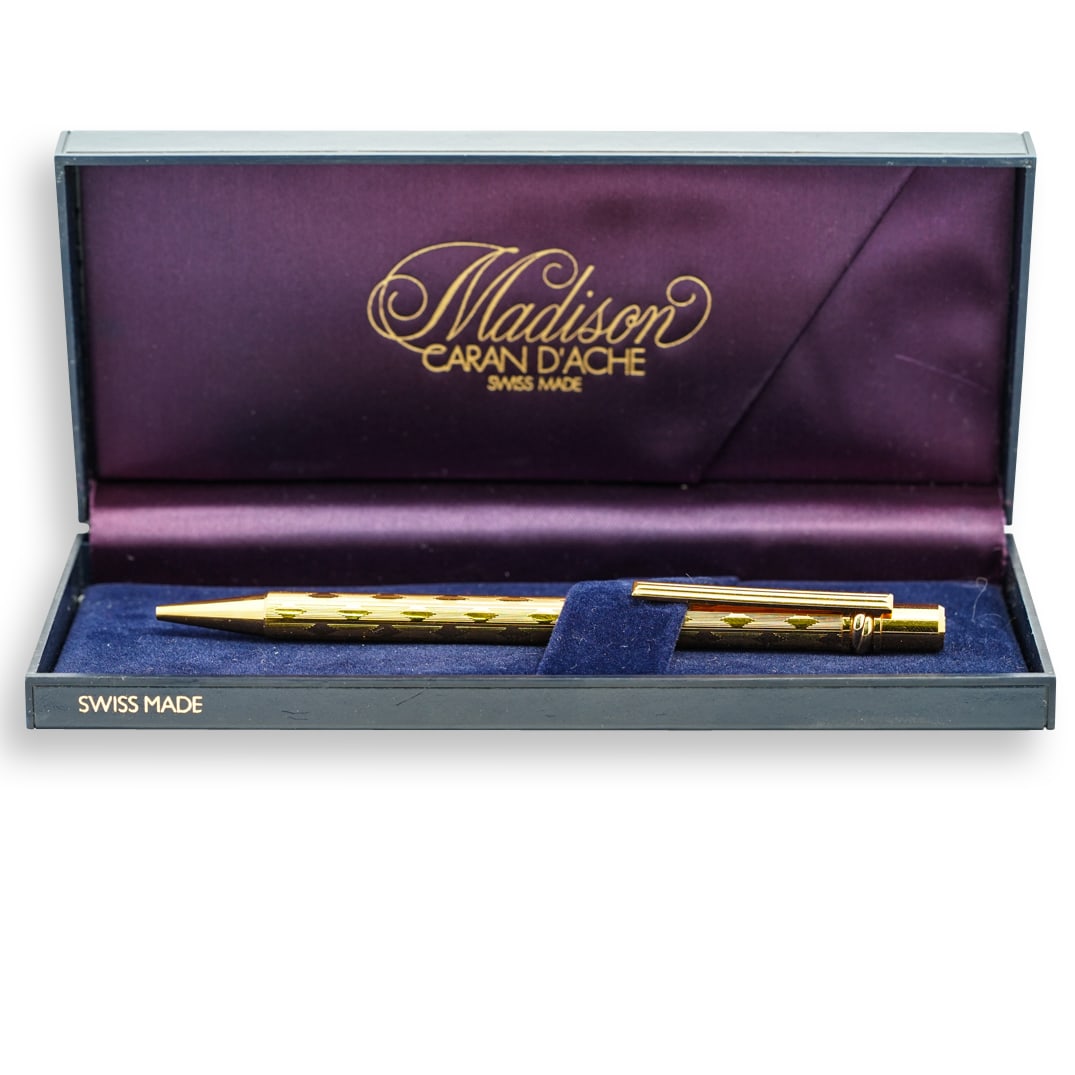 Cartier Must De Trinity Gold Plated Pen: DESCRIPTION: A Cartier Must De gold plated pen decorated with etched diamond patterns, further accented with a trinity band along the top. Incised "Must De Cartier" with S# B95911. Comes with with ret