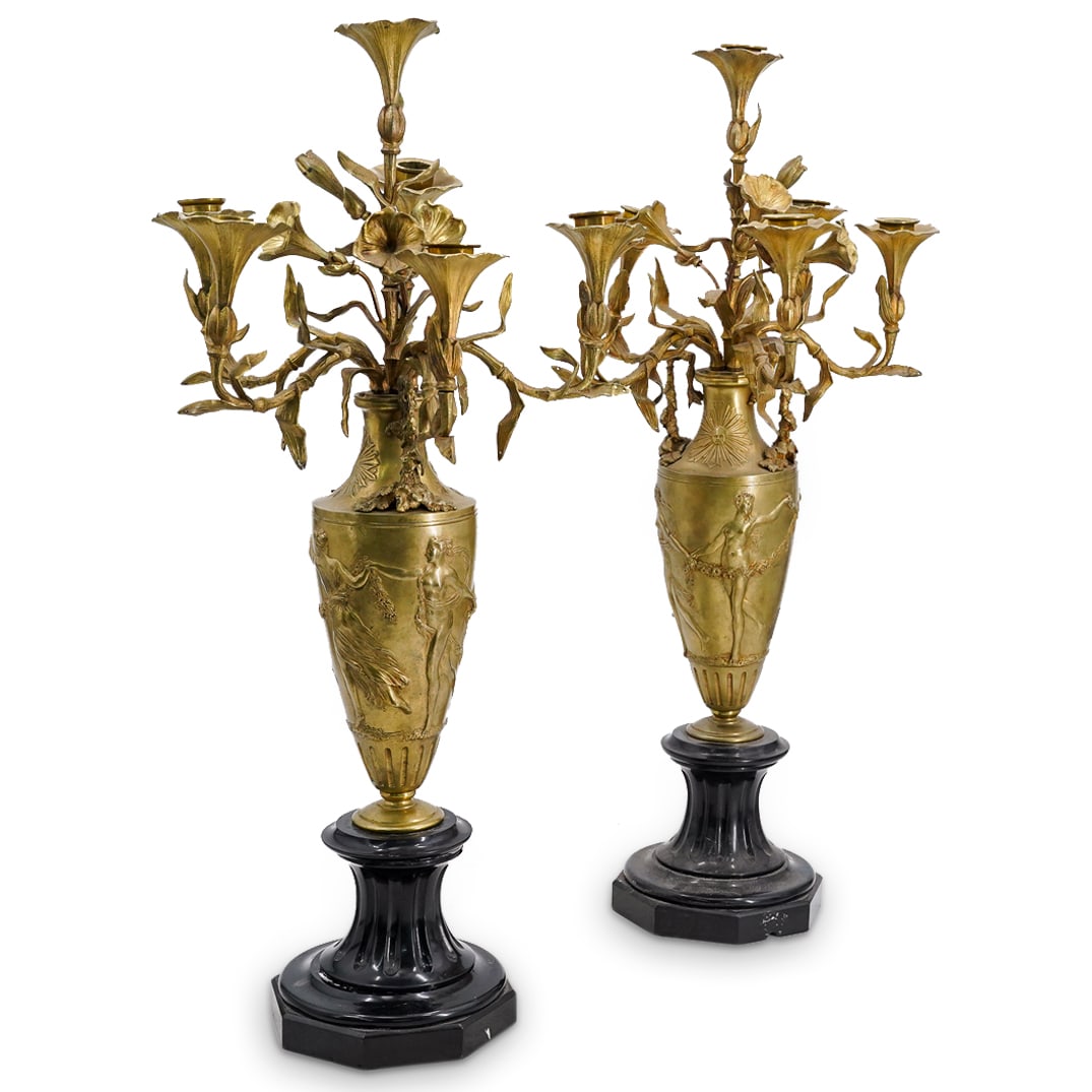 (2 Pc) Art Nouveau Bronze Satyr & Nymph Candelabras: DESCRIPTION: Pair of matching art nouveau era bronze candelabras, featuring vase shaped central body with a satyr holding hands with multiple nude nymphs in relief. They are connected by a large garla