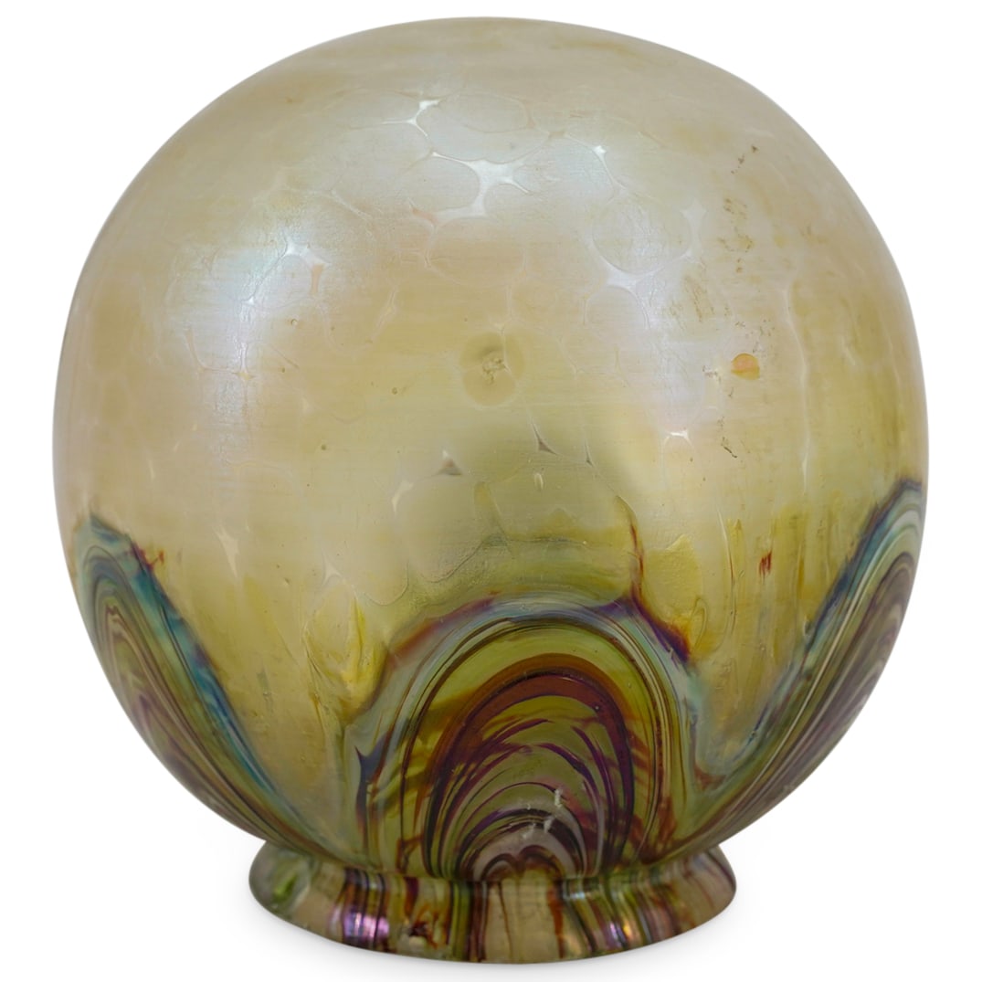 Loetz Iridescent Round Glass Lamp Shade: DESCRIPTION: Loetz iridescent yellow round glass lamp shade, featuring multicolored feathered designs near scalloped rim. CIRCA: 20th Century ORIGIN: Austria DIMENSIONS: H: 6" W: 6" L: 6" CONDITION: G