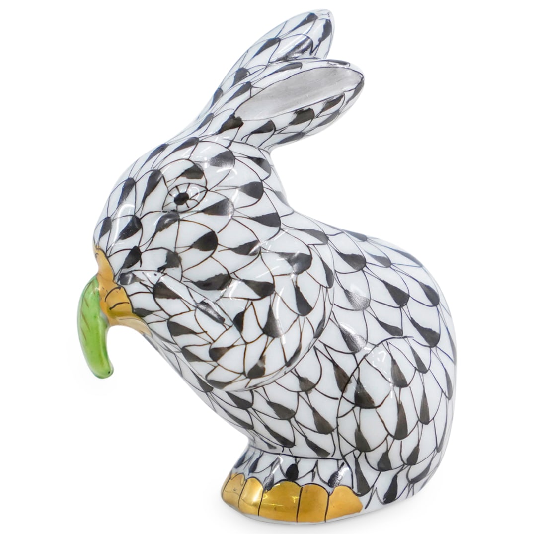 Herend Porcelain "Bunny Eating" Black Fishnet Figurine: DESCRIPTION: Herend porcelain figurine of a "Bunny Eating" embellished in a black hued fishnet pattern. Finished with gilded accents. Style: #15604. Marked along the underside with Herend stamps. CIRC