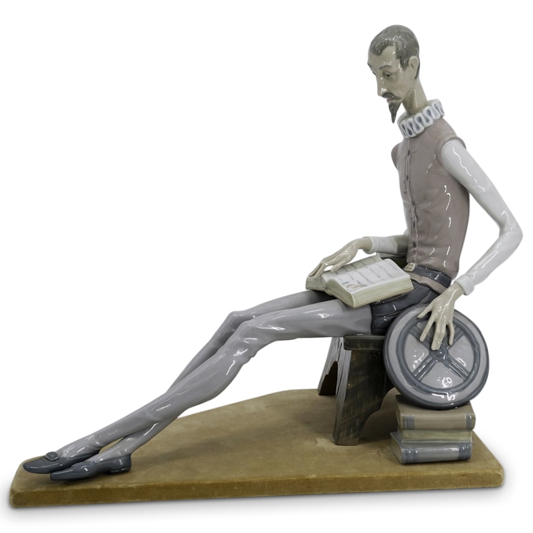 LLadro Glazed Porcelain "Don Quixote" Sculpture: DESCRIPTION: A Lladro glazed porcelain statue. Titled: "Don Quixote" features Don Quixote character sitting reading. Marked on bottom "Lladro, Nao, Made In Spain" rests on a felt wrapped base. CIRCA: