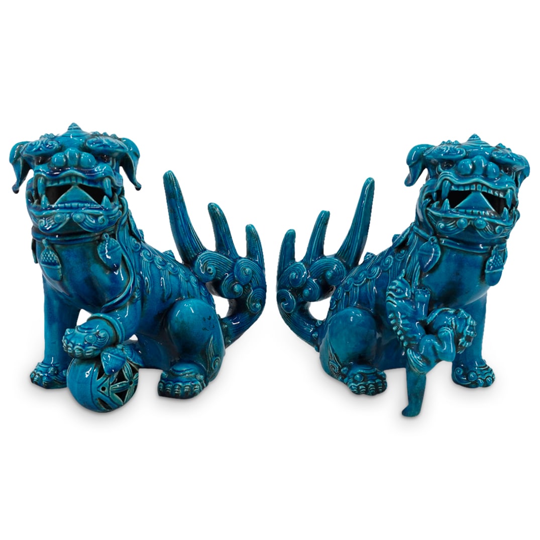 Pair Of Chinese Blue Glazed Porcelain Guardian Lions: DESCRIPTION: Two matching porcelain guardian lions coated in blue glaze - one male holding a pierced embroidered ball under his left front paw, one female supporting a rambunctious cub on her right fr