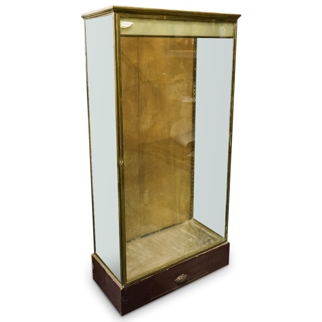 Modern French Display Cabinet: DESCRIPTION: A modern French display cabinet featuring gold-toned and silver-toned shelf supports. The cabinet includes a drawer at the bottom, marked with two "Etalages Vitrines / DeMaison" stamps. I