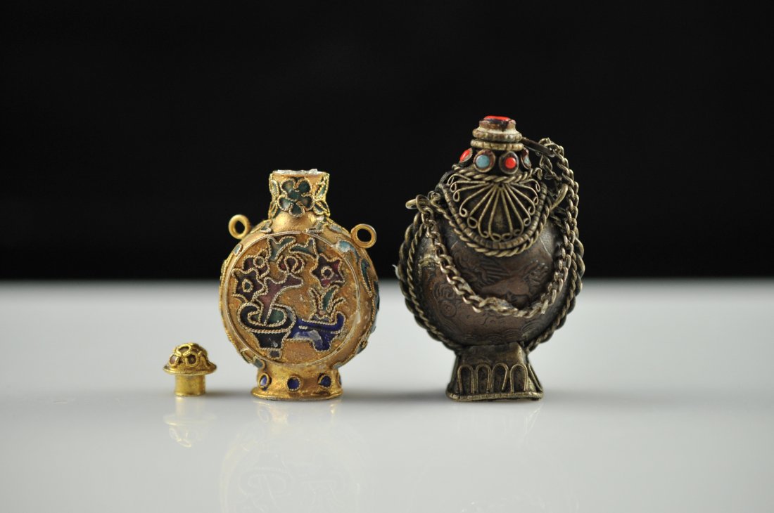 Lot of two Chinese metal and multi stone snuff bott: DESCRIPTION: Pair of Chinese antique metal and mixed stone snuff bottles. First bottle is a gold gilded metal with champleve floral design covering the entire bottle. Second bottle is mixed metal with