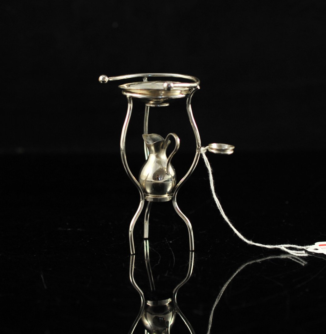 Miniature vintage sterling wash basin. Signed "Sauh: DESCRIPTION: Miniature vintage sterling wash basin. Contains four sterling pieces: The stand, the pitcher, the basin and a small bowl. Signed "Sauhette" underneath the basin. Floral motif on the side 