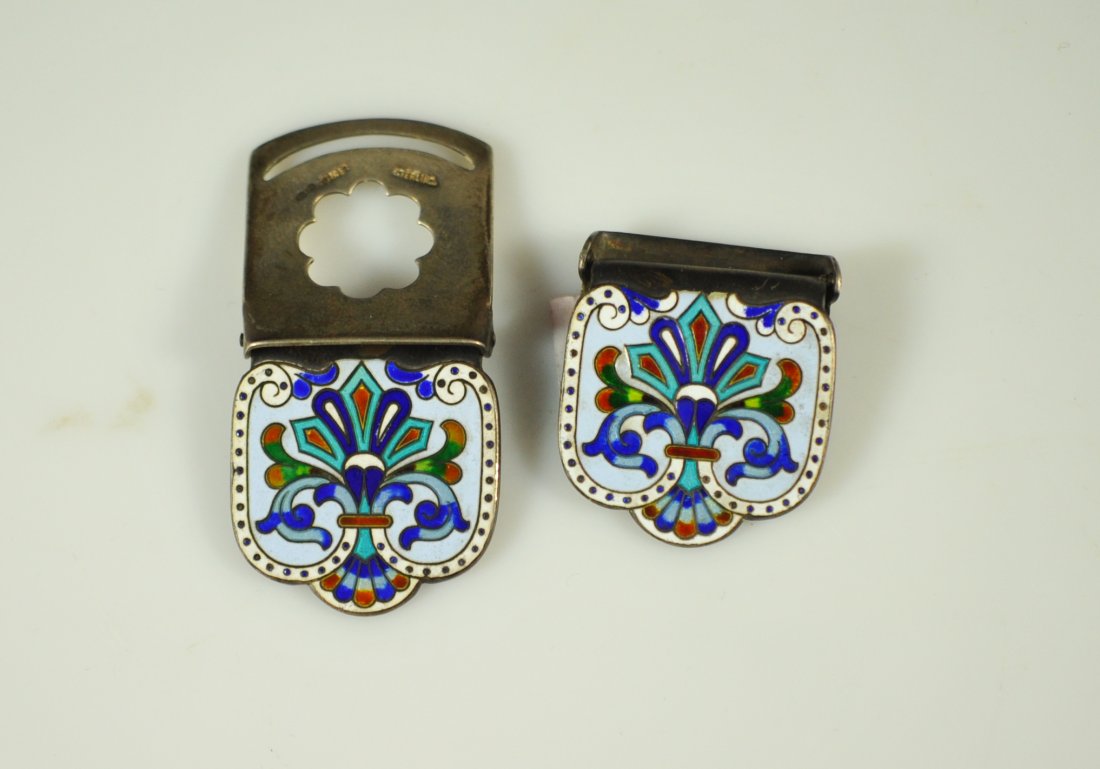 Pair of antique Russian sterling and enamel clips: DESCRIPTION: Set of two Russian sterling and enamel garment clips. Each garment clip is crafted from solid sterling silver in two parts joined by a primitive hinge design. The front boasts a deco bouq