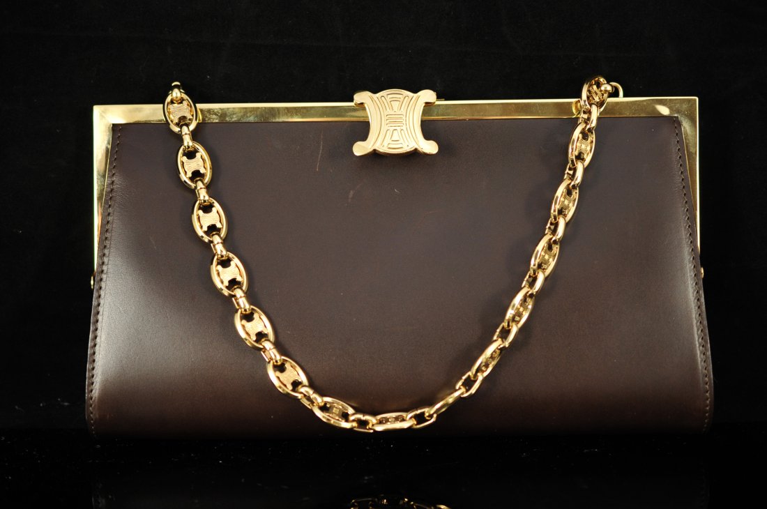 Authentic brown leather "Celine" evening bag: DESCRIPTION: Authentic Celine leather evening bag. Rich brown leather exterior with logo printed canvas interior. All hardware is gold over brass. Inside tag marked "Celine" "Made in Italy" with the s