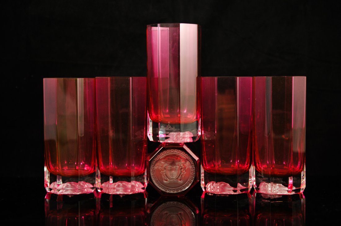 Set of six Versace by Rosenthal crimson glasses: DESCRIPTION: Set of six Versace by Rosenthal crimson glasses. Crimson crystal color with an octagon design. Frosted Medusa head on the bottom of each glass. Perfect condition. Signed "Rosenthal Versac