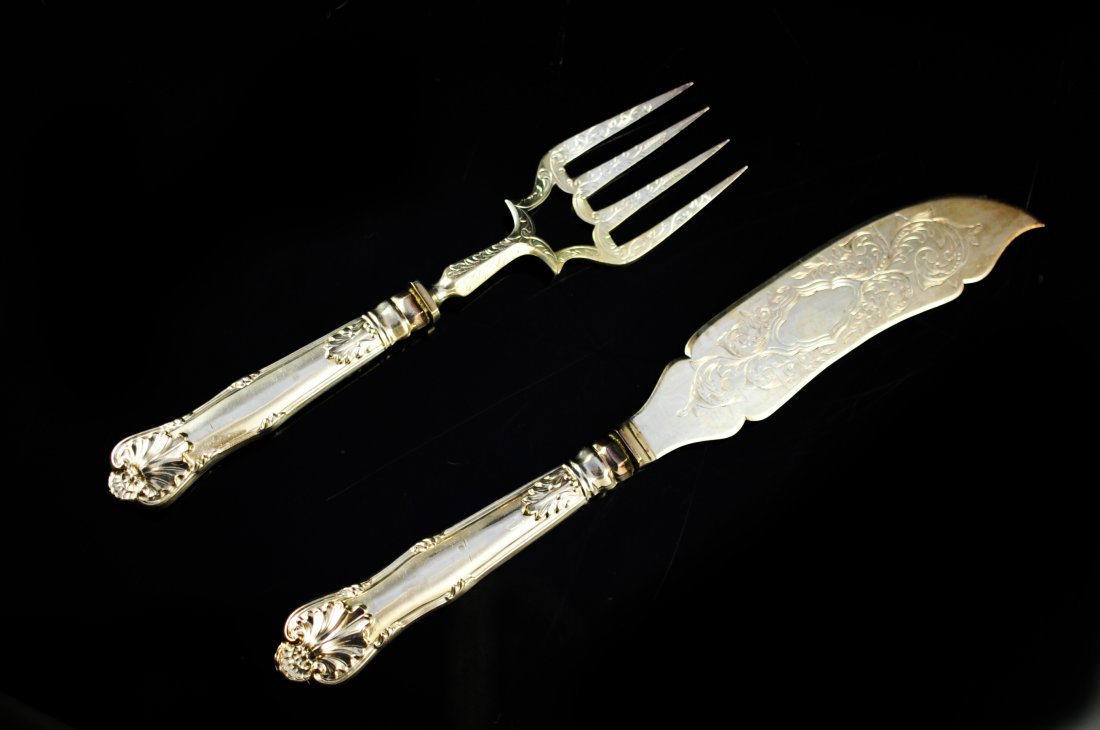 Matching sterling fork and knife serving set: DESCRIPTION: Matching sterling fork and knife serving set. Large sterling serving pieces with ornate floral motif engraved design on the blade and the fork. Baroque handles with elegant accent. Full h