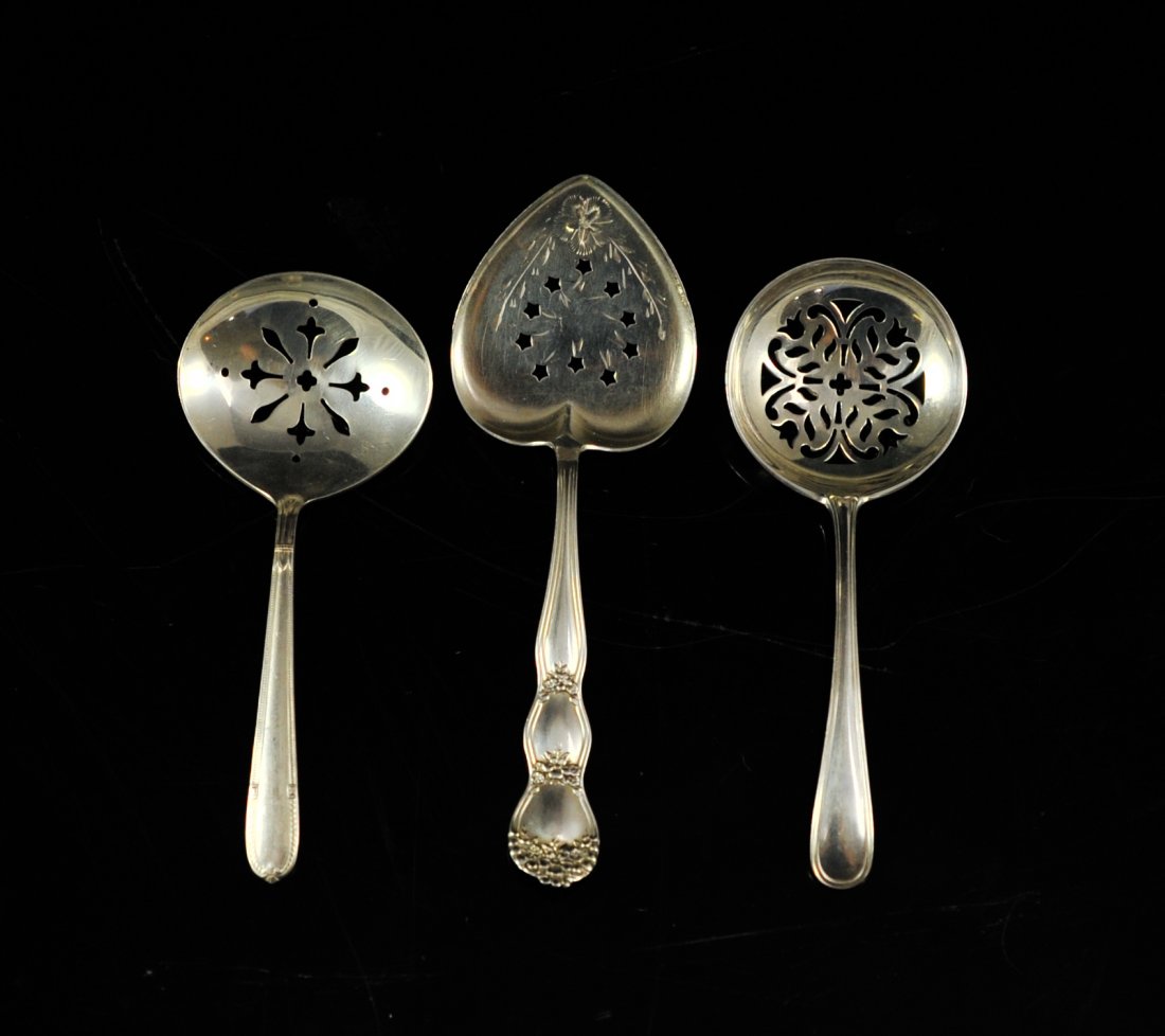 Three sterling mote style spoons. Hallmarked: DESCRIPTION: Three sterling mote style spoons. Each spoon with it's own colander style design. Two spoons with a rounded head with the third having a spade shaped head. All hallmarked sterling. 63.2 g