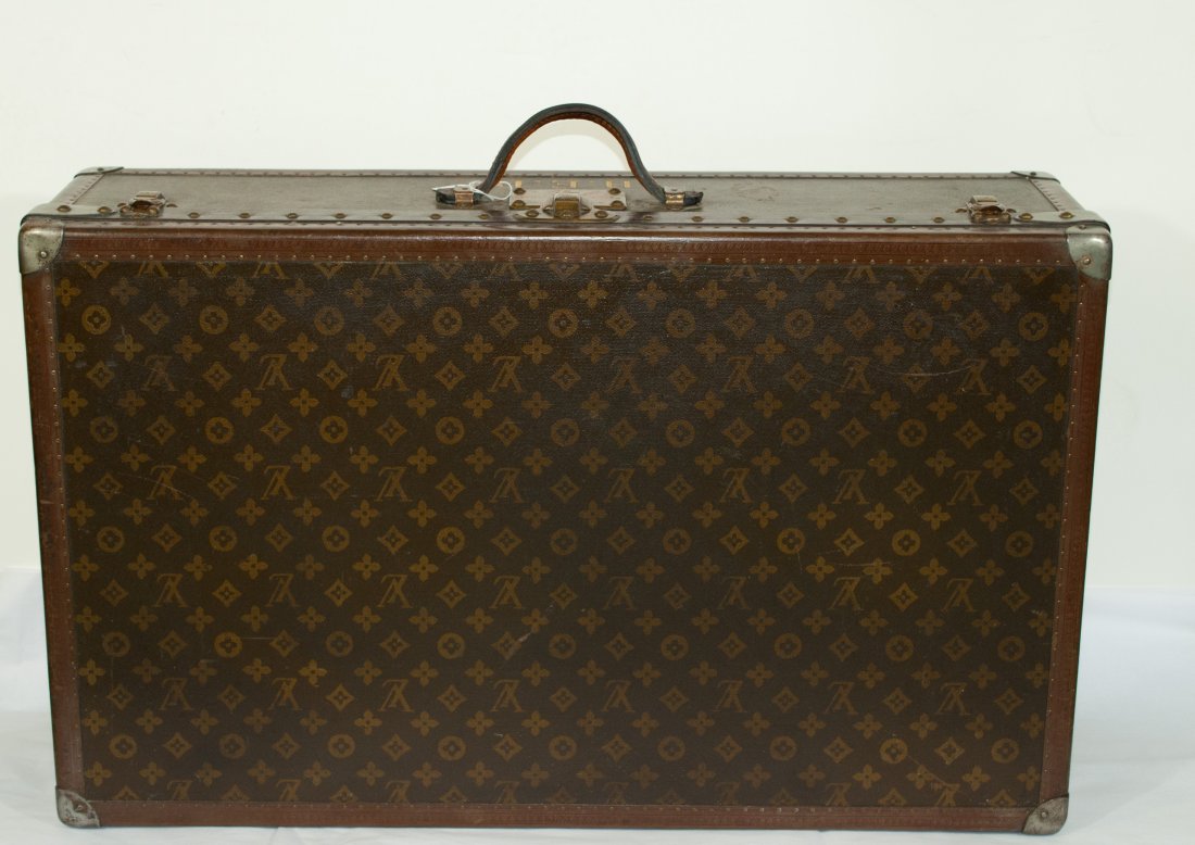 Vintage original Louis Vuitton hard suitcase.: DESCRIPTION: Original Louis Vuitton monogrammed hard suitcase. All original brass and metal hardware with rich brown monogrammed leather around edges. Dated back to the 1930's. Double deck cloth inter