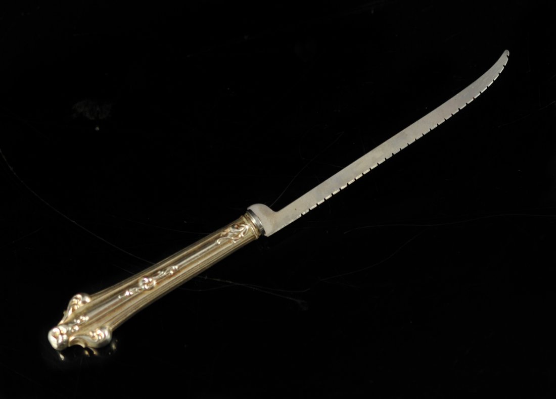 Antique sterling baroque serrated knife: DESCRIPTION: Antique sterling baroque serrated knife. Intended for filleting meat. Elegant raised design handle with stainless blade. Marked "sterling" on the handle 35.1 grams CIRCA: Mid 1900's ORIGI