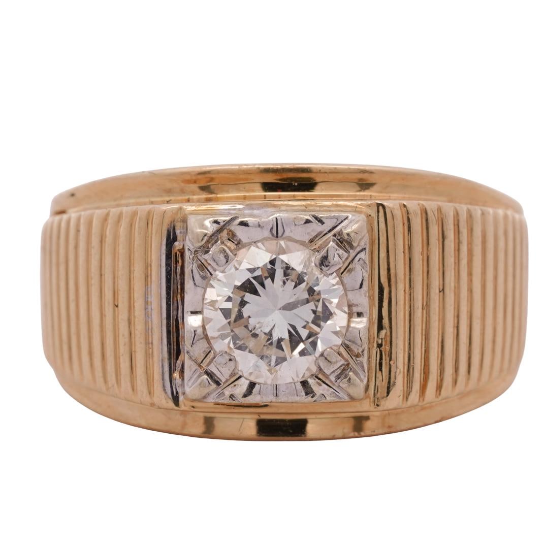 18k Gold and Diamond Ring: DESCRIPTION: 18k gold ring, with a masculine design featuring a wide band with a ridged pattern. The centerpiece is a round cut diamond (approx. 1 carat) set in a square bezel setting. Hallmarked "18k