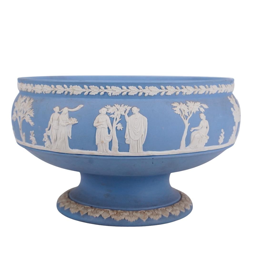 Wedgwood Jasperware Centerpiece Bowl: DESCRIPTION: Wedgwood jasperware ceramic centerpiece pedestal bowl decorated with applied foliage motifs and neoclassical figures. Marked on underside. CIRCA: Mid 20th century ORIGIN: English DIMENSIO