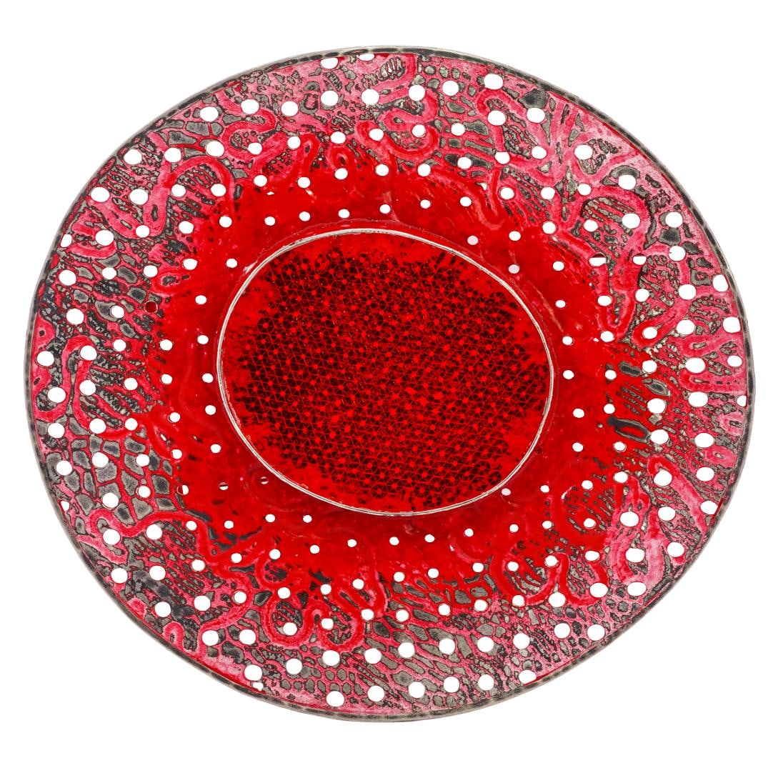 Daniel Kruger (South African, B. 1951) Silver & Acrylic Glass Brooch: DESCRIPTION: Daniel Kruger (South African, B. 1951) Pierced silver circular brooch decorated with red pigment, featuring red reflector covered with acrylic glass in the center. Stamped "DK" CIRCA: 21s