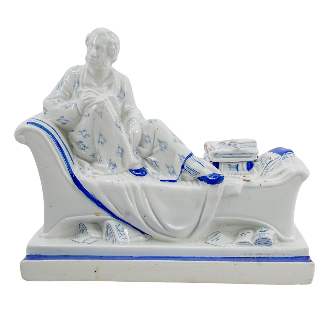 Soviet Porcelain Pushkin Inkwell (Lomonosov State Porcelain Factory): DESCRIPTION: Lomonosov porcelain inkwell, after a model by Natalia Danko, depicting the poet Alexander Pushkin seated on a chaise lounge, the lid in the form of a book. Stamped green mark at underside