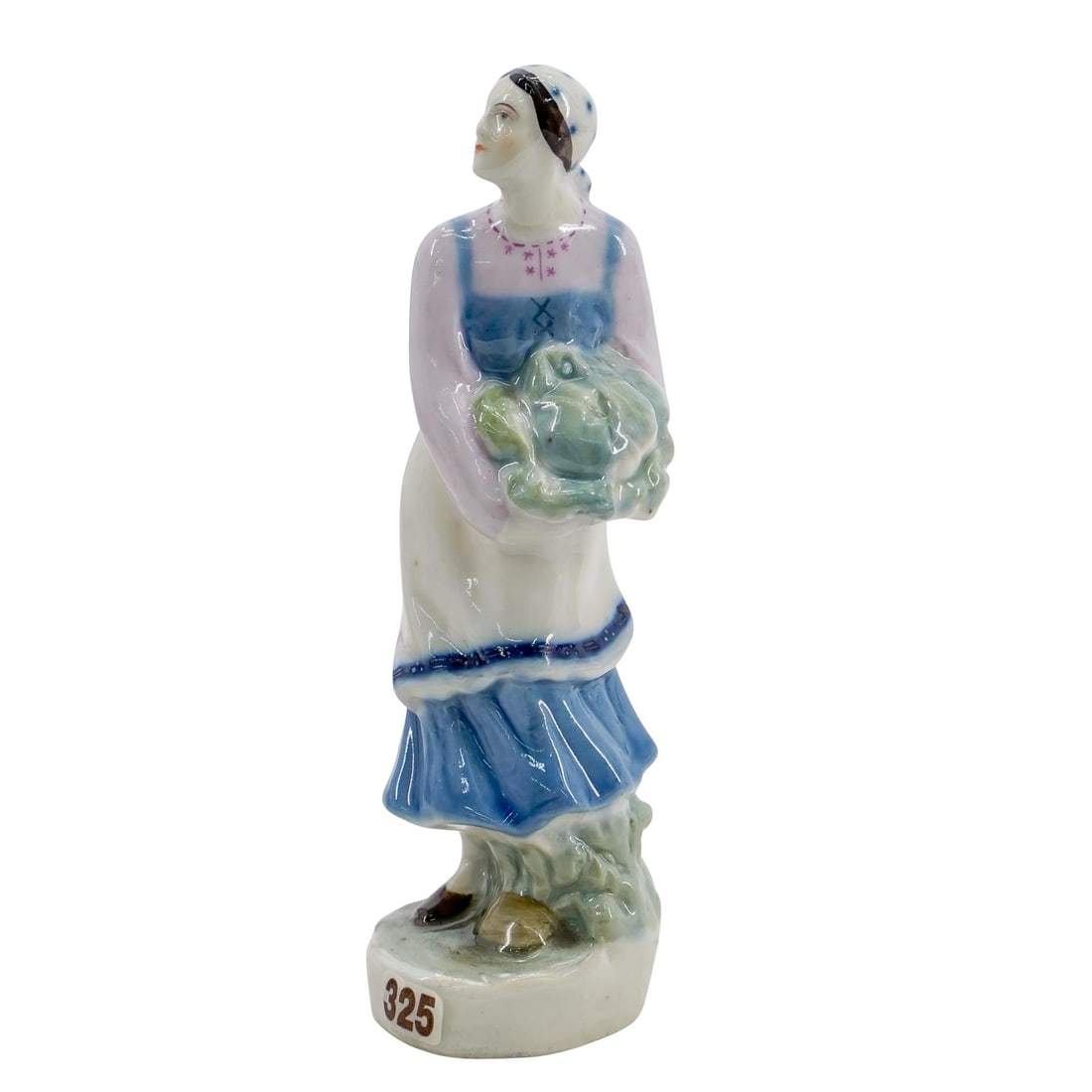 Soviet Porcelain Woman With Cabbage (Lomonosov State Porcelain Factory): DESCRIPTION: Lomonosov porcelain figure, after a model probably by Natalia Danko, depicting a peasant woman holding a cabbage. Stamped mark at underside. Provenance: Private collection of Gregor Sharg