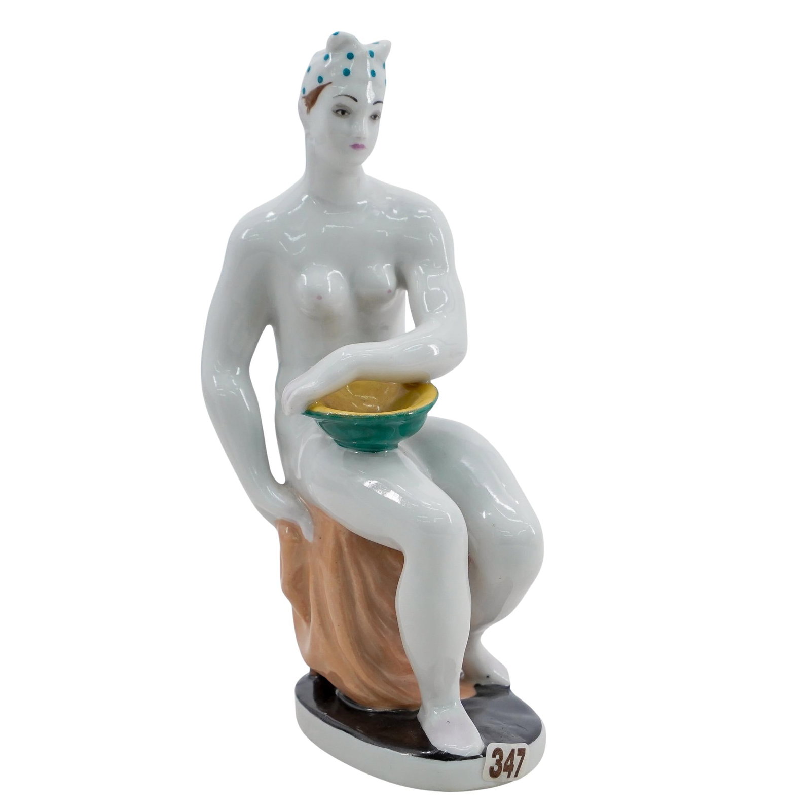 Soviet Porcelain Seated Nude Figure (Lomonosov State Porcelain Factory): DESCRIPTION: Lomonosov porcelain figure, after a design by Alexander Matveev, depicting a seated nude holding a bowl. Stamped blue mark at underside. Provenance: Private collection of Gregor Shargorod