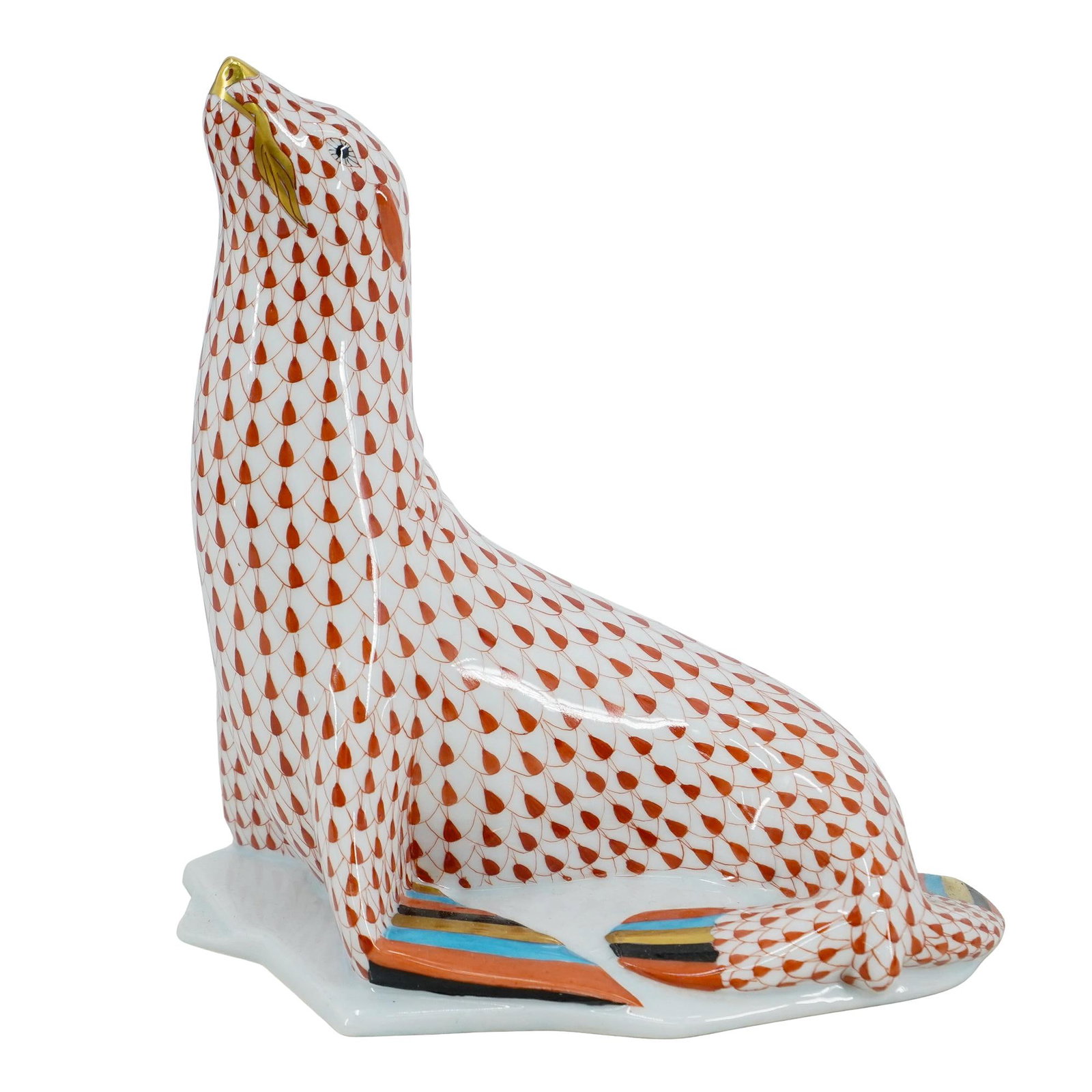 Herend Porcelain "Sea Lion On Ice" Rust Fishnet Figurine: DESCRIPTION: Herend porcelain figurine of a "Sea Lion On Ice" embellished in a rust hued fishnet pattern. Finished with gilded accents. Style:#5223. Marked along the underside with Herend stamps. CIRC