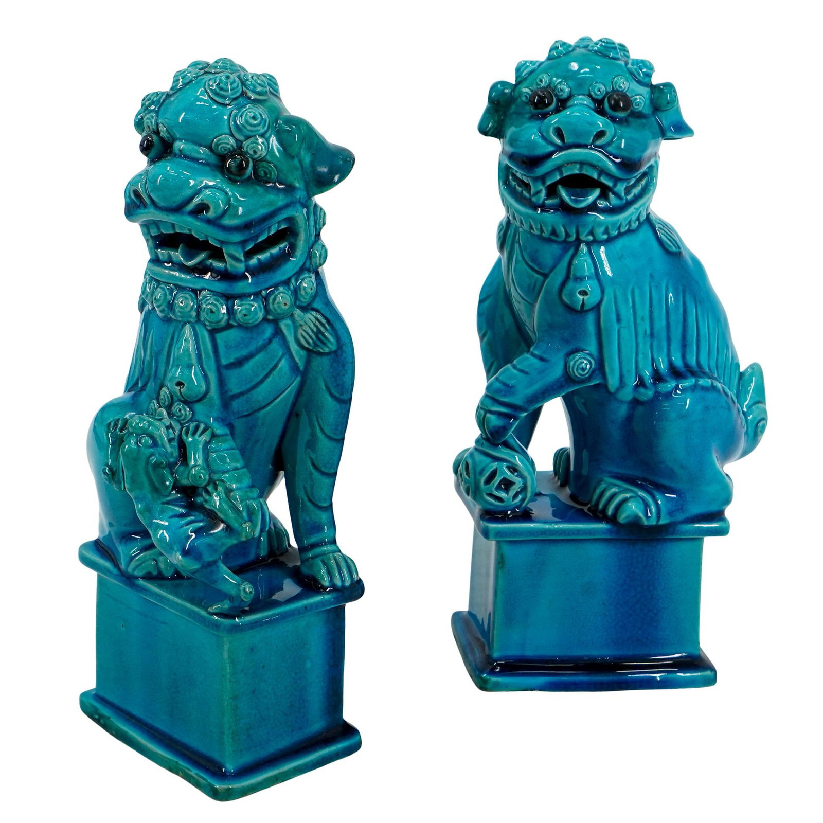 Pair Of Vintage Chinese Porcelain Guardian Lions: DESCRIPTION: Two vintage matching porcelain guardian lions coated in a blue glaze - one male holding an embroidered ball beneath his left front paw and looking to his left, one female looking right wi