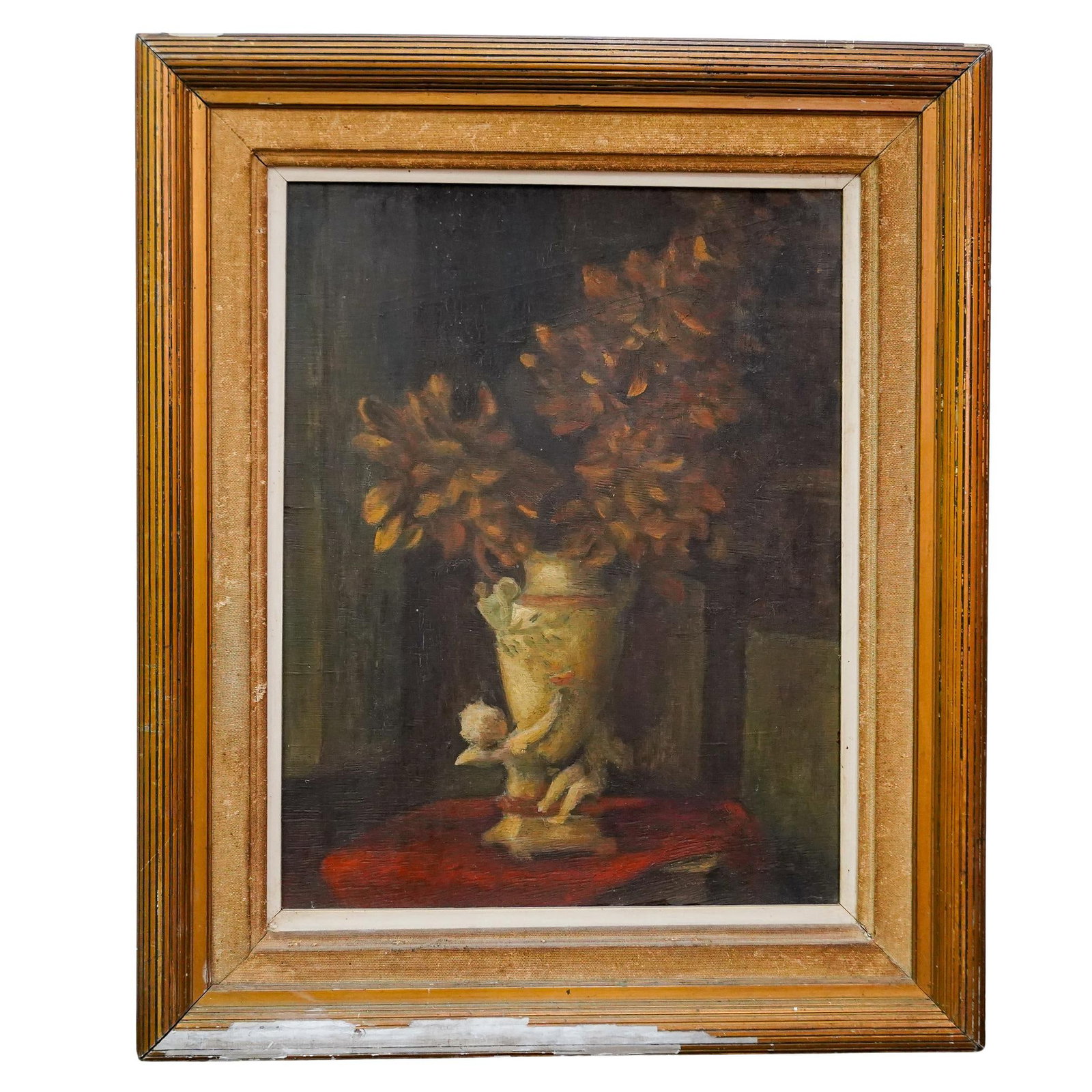 Antique European Chiaroscuro Still Life Oil On Board: DESCRIPTION: Antique oil on board painting depicting a still life of yellow flowers in a putto supported vase on a clothed table. Mounted in a fabric lined, gilt wooden frame. CIRCA: Early 20th Centur