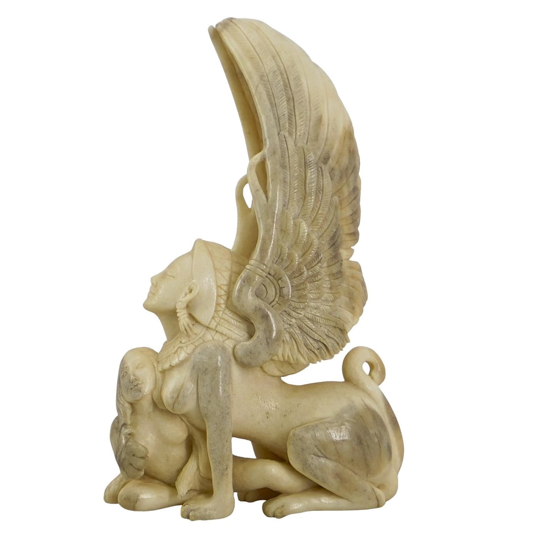 Antique Carved Antler Erotic Sphinx And Woman Figurine: DESCRIPTION: Erotic figurine carved from antler and depicting a sphinx wearing a feathered headdress and a nude human woman embracing. CIRCA: 20th Century ORIGIN: American DIMENSIONS: H: 6" W: 1.75" L