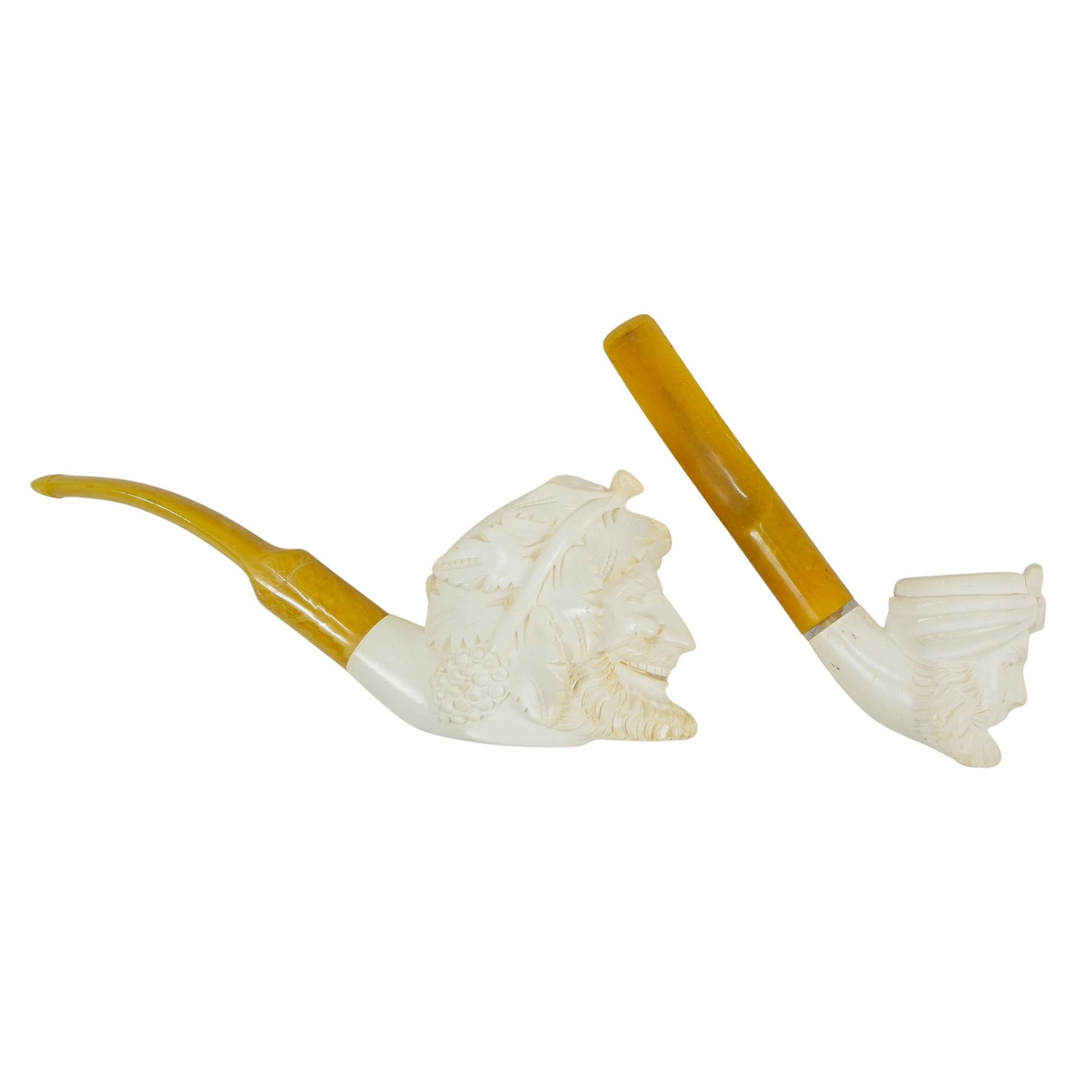 (2 Pc) Carved Meerschaum & Bakelite Pipes: DESCRIPTION: Pair of vintage carved meerschaum pipes, each featuring a bearded figural head as the bowl with yellow bakelite mouthpieces. Larger pipe includes case. CIRCA: 20th Century ORIGIN: Turkey 