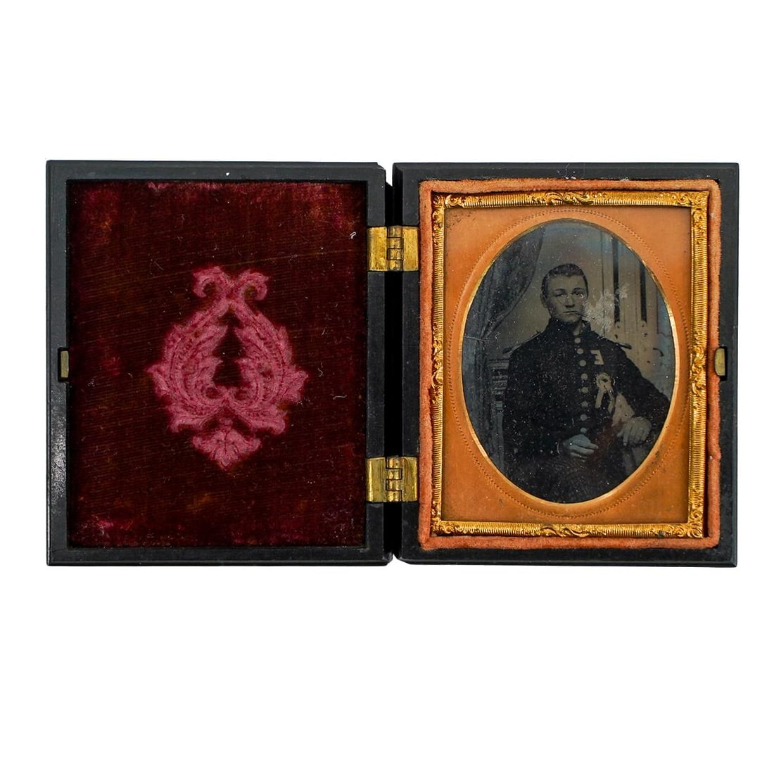 Civil War Soldier Daguerreotype in Gutta Percha Case: DESCRIPTION: Daguerreotype of civil war soldier, seated and house in gutta percha case. Provenance: Private Pennsylvanian Estate CIRCA: 1860's ORIGIN: USA DIMENSIONS: H: 3.5" W: 0.75" L: 2.5" CONDITIO