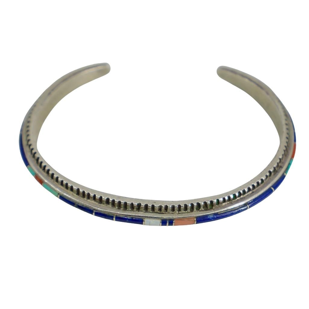 Rose Ann Long Navajo Silver & Stone Cuff: DESCRIPTION: Rose Ann Long Navajo sterling silver cuff bracelet, featuring stone inlay throughout consisting of turquoise, coral, and lapis. Hallmarked and signed. Total weight: 21.84g CIRCA: 20th Cen