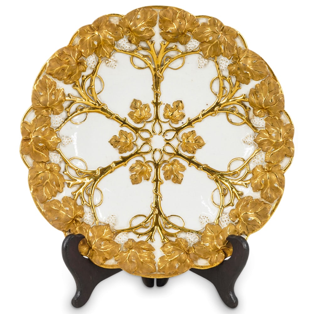 Antique Meissen Porcelain Centerpiece Bowl Plate: DESCRIPTION: An antique Meissen porcelain centerpiece bowl plate, designed with grapevines and grape cluster motifs in relief, in white glazed porcelain and further decorated with overall gold gilt ac