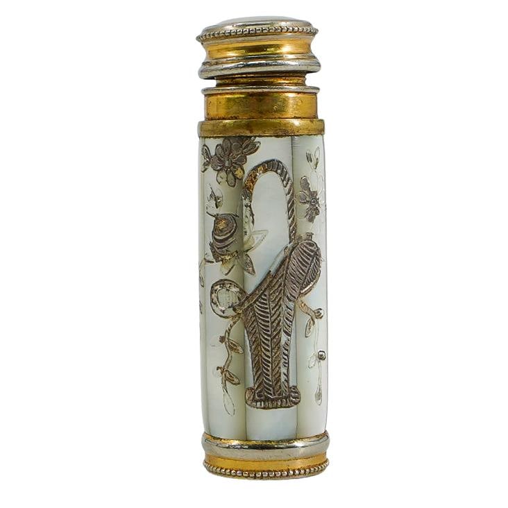 Mother of Pearl Pump Purse Atomizer: DESCRIPTION: Mother of pearl pump purse atomizer, featuring engraved design on the front of a basket with flowers, and brass accents. CIRCA: 20th Century ORIGIN: Continental DIMENSIONS: H: 2.75" CONDI