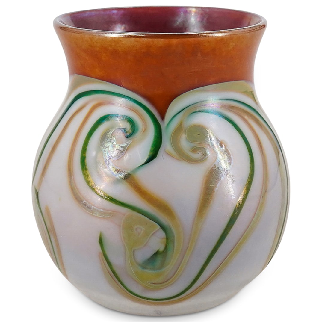 Louis Comfort Tiffany Favrile Glass Bulbous Cabinet Vase: DESCRIPTION: Favrile glass cabinet vase by Louis Comfort Tiffany featuring iridescent polychrome swirls around its bulbous body. Incised "L.C.T." and stickered on underside. CIRCA: 1870's - 1910's ORI