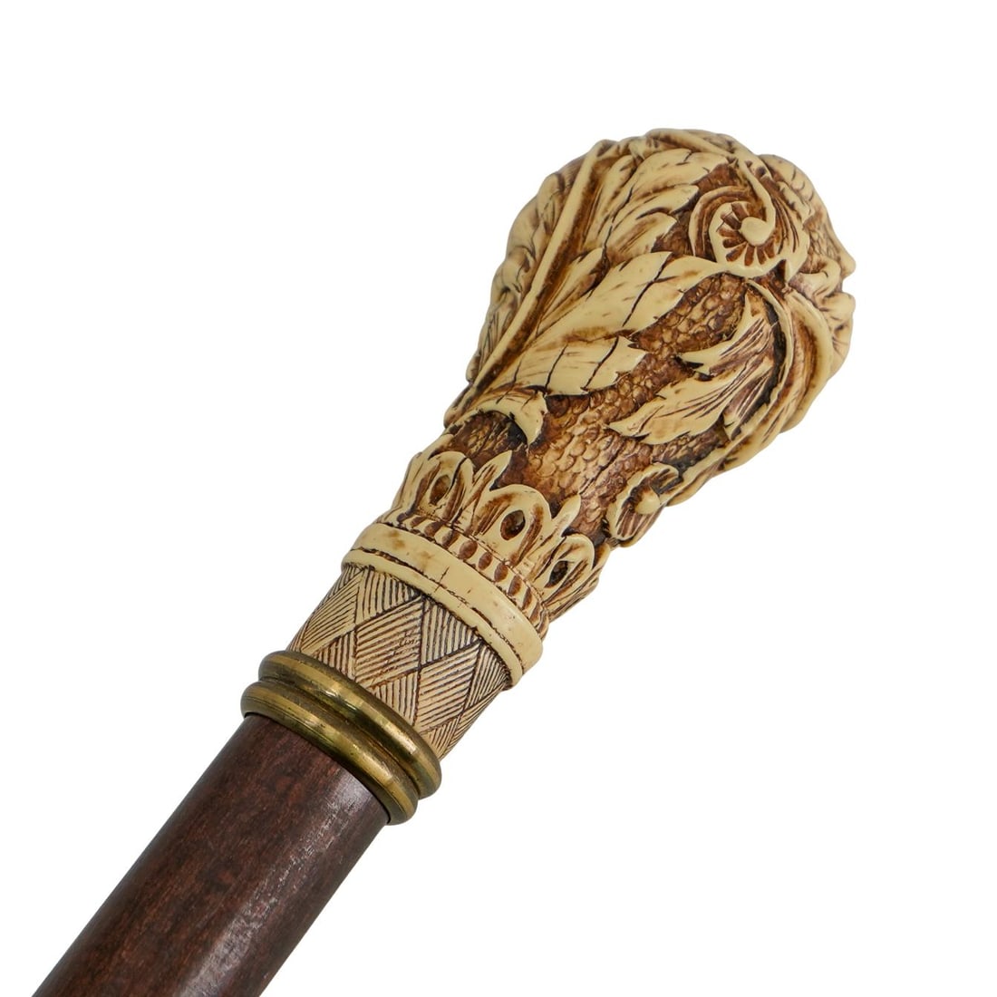 Antique Carved Bone And Wood Foliage Handled Cane: DESCRIPTION: Antique carved wood cane featuring a carved bone handle sporting foliage reliefs and a gilt bronze trim. CIRCA: 19th to early 20th Century ORIGIN: England DIMENSIONS: W: 1.5" L: 35.75" CO