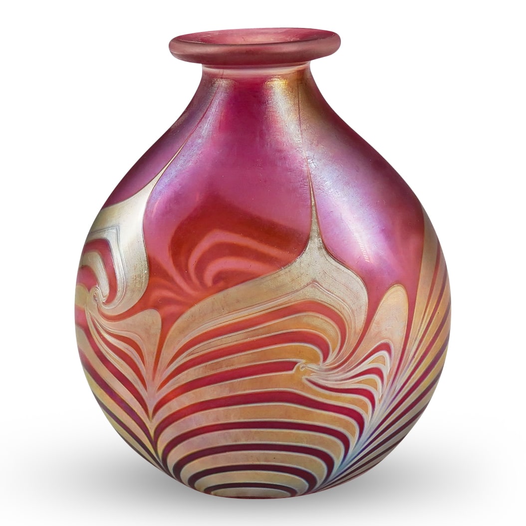 Signed Correia Iridescent Art Glass Perfume Bottle: DESCRIPTION: Signed Correia Iridescent Art Glass Perfume Bottle decorate with a pull feather design on a cranberry hued ground bottle. With signature on the underside. CIRCA: 20th Century ORIGIN: USA 
