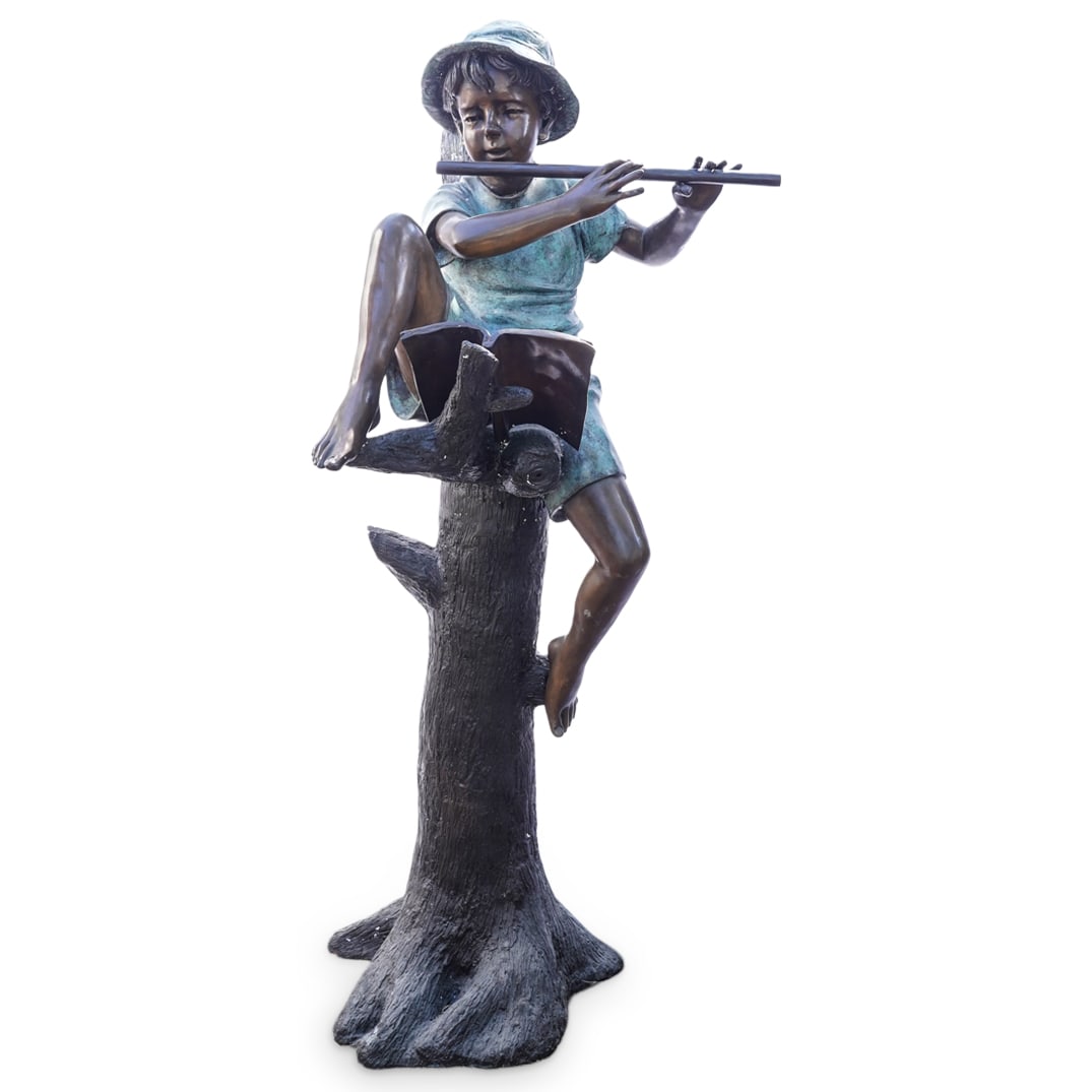 Bronze Boy with Flute Sculptural Garden Fountain: DESCRIPTION: Bronze sculptural garden fountain, depicting a young boy sitting on a tree branch playing a flute with an open music book next to him. His shirt and hat feature a turquoise verdigris fini