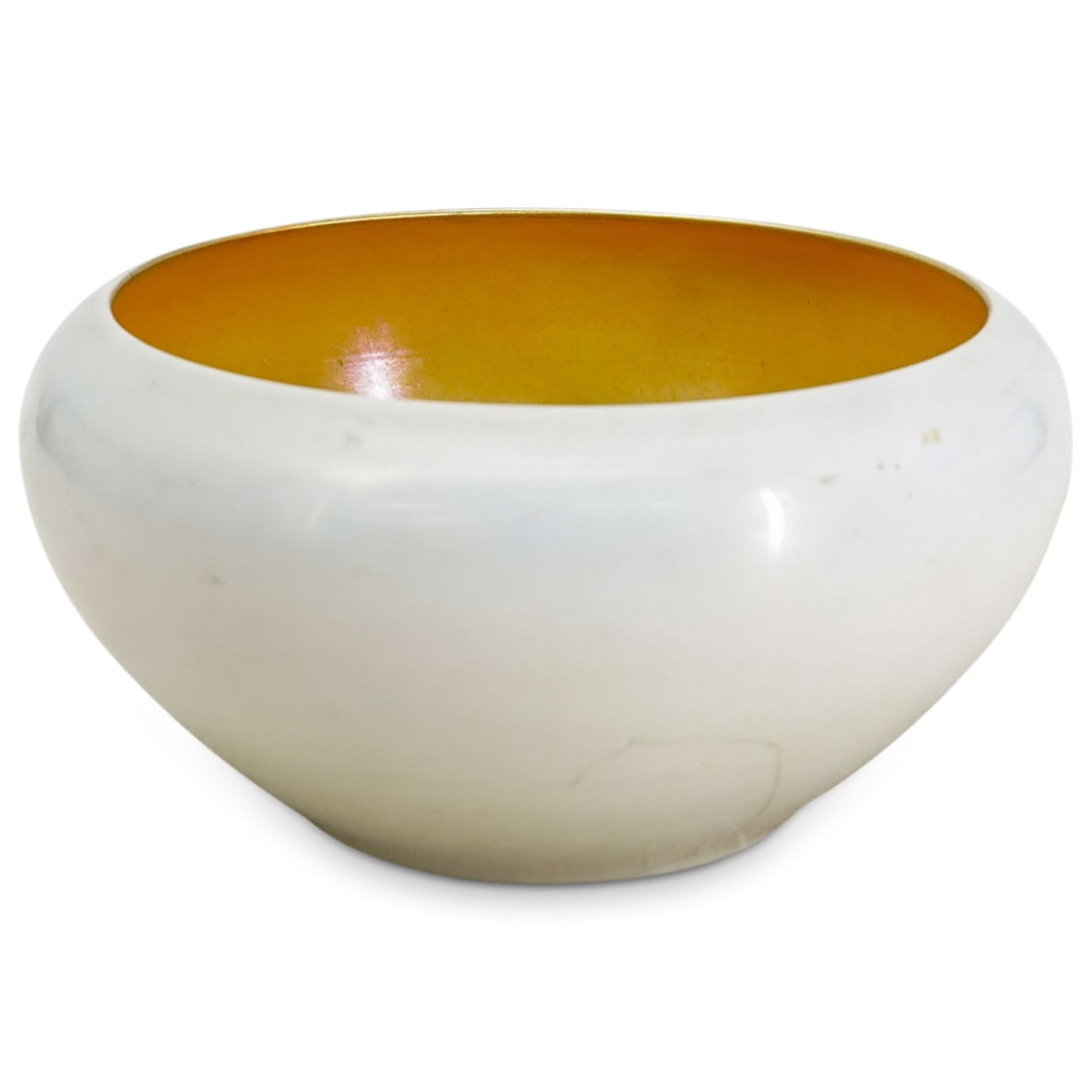 Steuben White Aurene Glass Bowl: DESCRIPTION: Steuben white aurene glass bowl, featuring a gold aurene interior. CIRCA: 20th Century ORIGIN: USA DIMENSIONS: H: 4" D: 7.75" CONDITION: Bowl has repair from one side through bottom. Unle