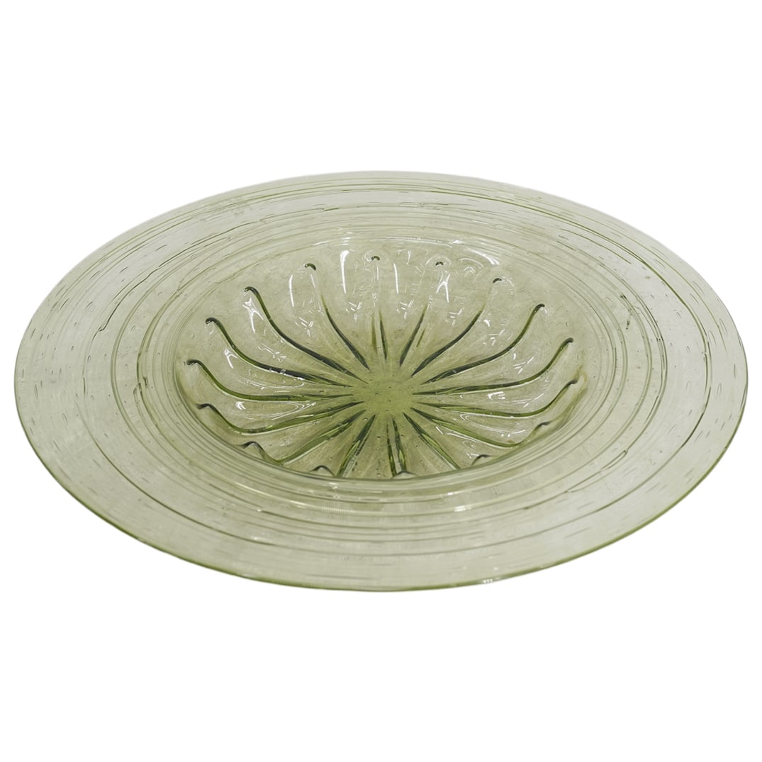 Steuben Green Glass Centerpiece Bowl: DESCRIPTION: Steuben green glass centerpiece bowl, featuring controlled bubbles interspersed throughout, and a ribbed design in the bowl CIRCA: 20th Century ORIGIN: USA DIMENSIONS: H: 2.25" D: 16: CON