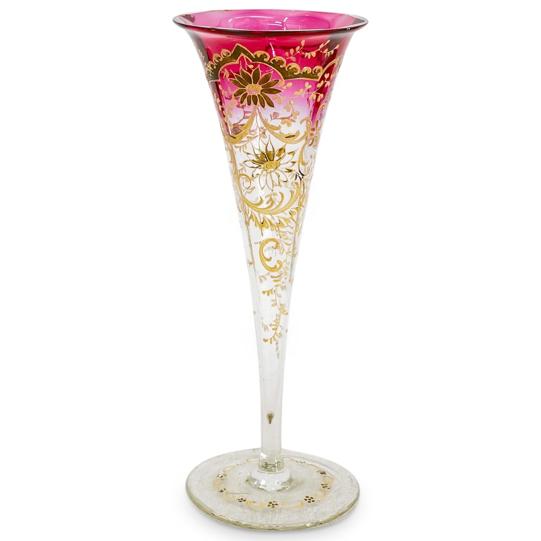 Moser Cranberry to Clear Fluted Glass Vase: DESCRIPTION: Moser cranberry to clear fluted glass vase, featuring hand painted gilt florals, foliage, and scrollwork throughout. CIRCA: 20th Century ORIGIN: Czech DIMENSIONS: H: 13 7/8" D: 5" CONDITI