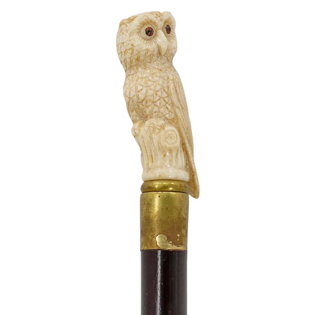 Vintage Wood and Carved Bone Owl Cane: DESCRIPTION: A vintage cane comprised of a wooden foundation, fitted with a carved bone handle depicting an owl, completed with glass eye inserts. CIRCA: Mid-Late 20th Cent. ORIGIN: USA DIMENSIONS: H: