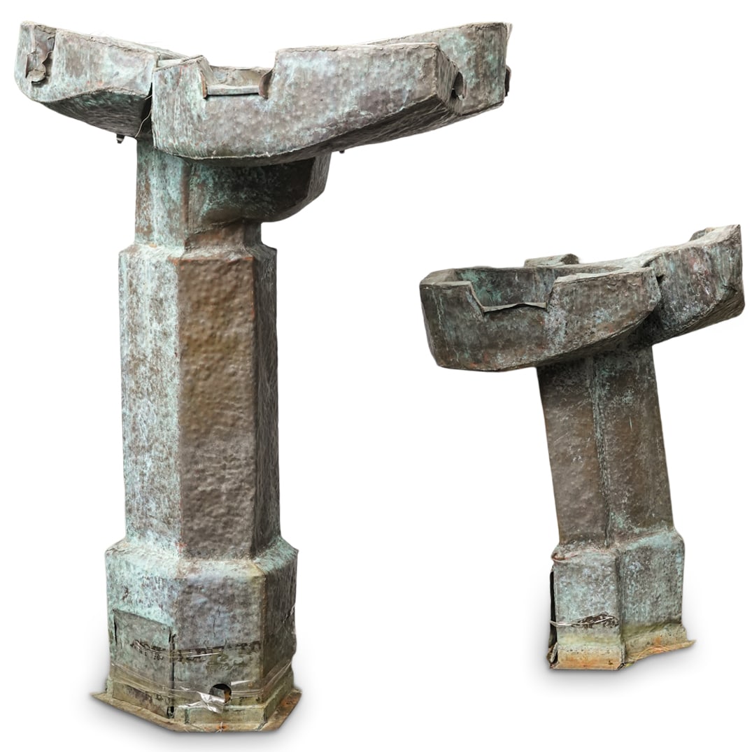 Large Architectural Sculptural Fountain: DESCRIPTION: Large weathered architectural sculptural fountain, designed with a broad, leaf like design at its base. The central column is tall and faceted, tapering slightly as it ascends leading to 