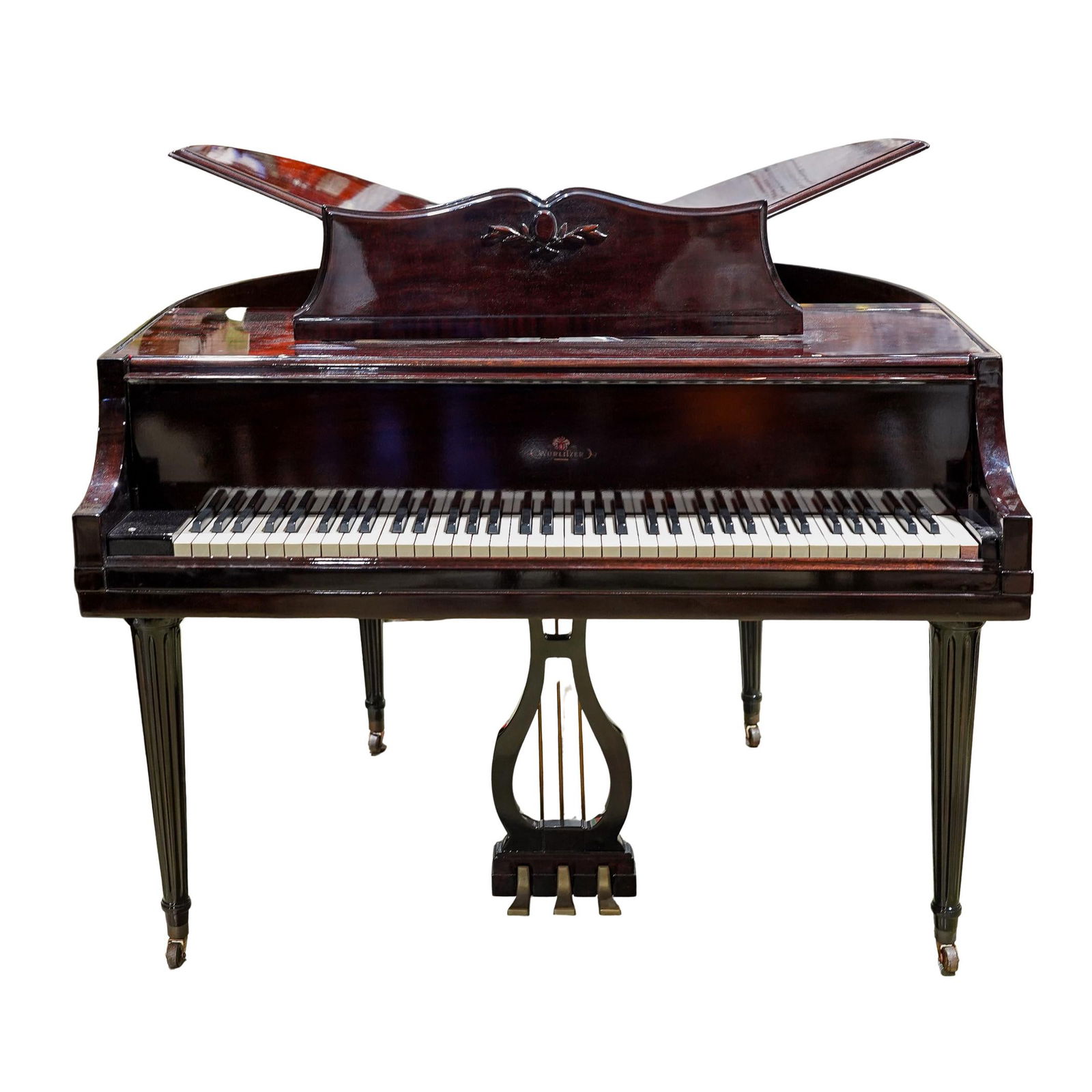 Wurlitzer Butterfly Baby Grand Piano: DESCRIPTION: Wurlitzer Butterfly Baby Grand Piano, features a lacquered brown wood foundation. CIRCA: 20th Cent. ORIGIN: Germany DIMENSIONS: H: 40" x W: 56.25" x L:70" CONDITION: Minor Scratching to f