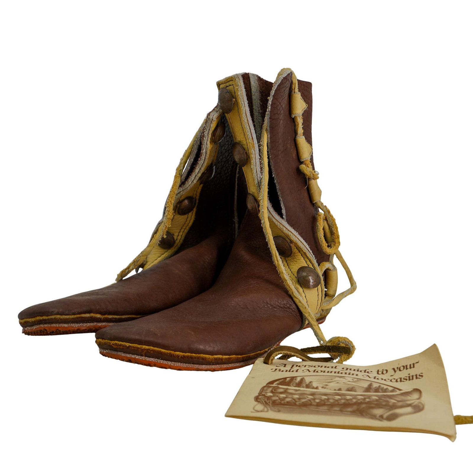 (2 pcs) Bald Mountain Moccasins Boots: DESCRIPTION: Pair of Bald Mountain Moccasins brand moccasin boots. Unsized. Includes "A Personal Guide to Your Bald Mountain Moccasins" pamphlet. CIRCA: 20th century ORIGIN: United States DIMENSIONS: 