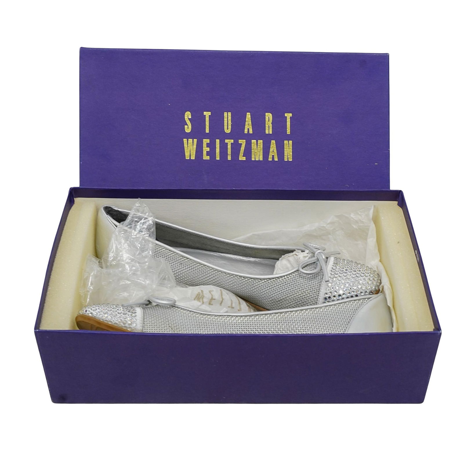 Stuart Weitzman 'Ideal' Silver Leather & Rhinestone Flat Shoes: DESCRIPTION: Stuart Weitzman Ideal Silver Nappa Rhinestone and Bow Flats Shoes. Size 6 1/2. With original box. CIRCA: 20th Century ORIGIN: USA DIMENSIONS: Size 6 1/2. CONDITION: Good pre-owned conditi