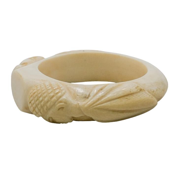 Carved Bone Bangle Bracelet W/ Female Figural Carvings: DESCRIPTION: Vintage carved bone bangle bracelet decorated with a pair of female figural torso carvings. CIRCA: 20th Century ORIGIN: Asia DIMENSIONS: H: 7/8" W: 2 1/2" (W: 3 1/2" exterior) CONDITION: 