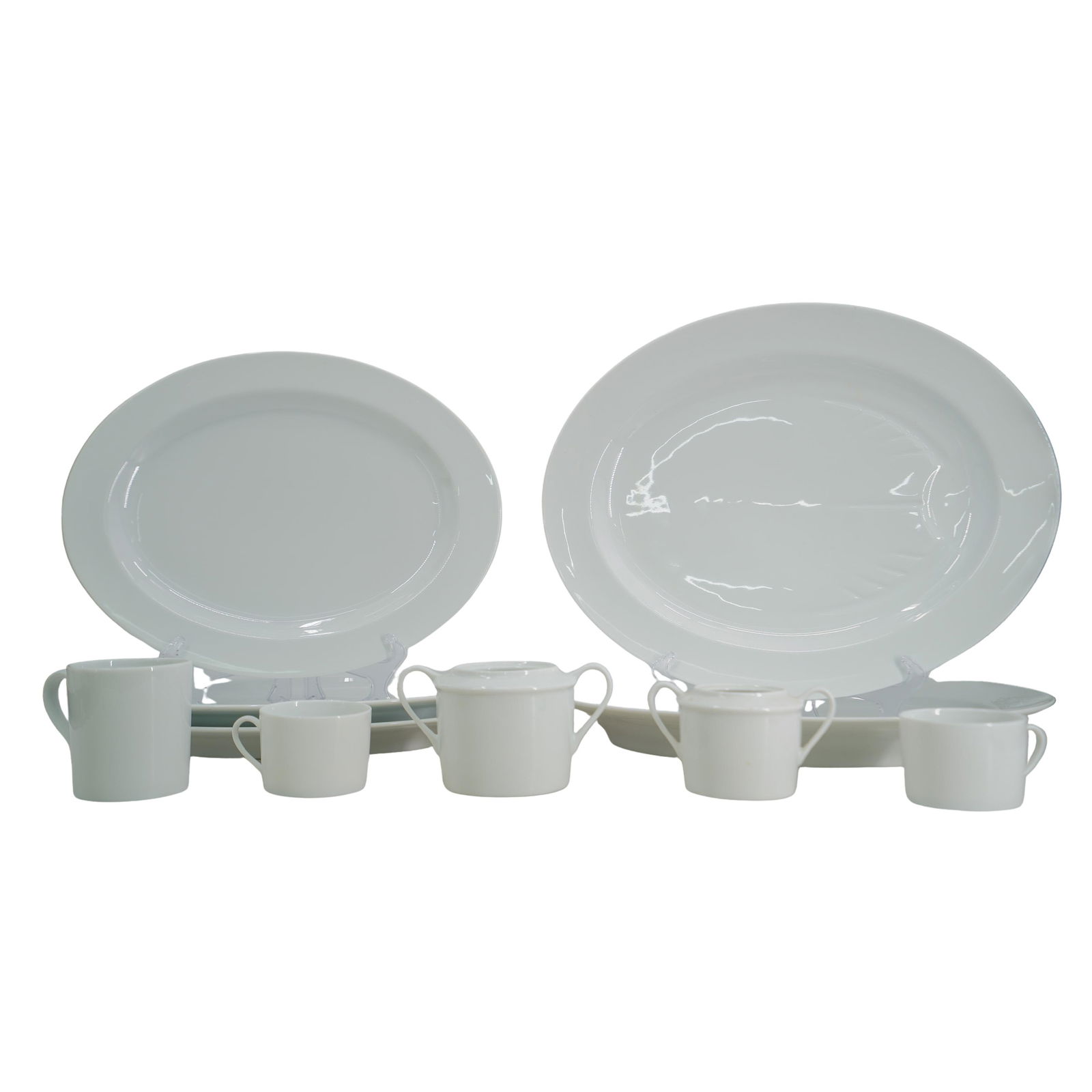 (10 pcs) Bernardaud France "Phoebe" Porcelain Assorted Homeware: DESCRIPTION: White Bernardaud France porcelain platters, three cups and two sugar containers. From the "Phoebe" collection. x2 large platters measure 17"x 13.75" x3 medium platters measure 15.25" x 12